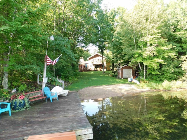 exterior space with a deck with water view and a lawn