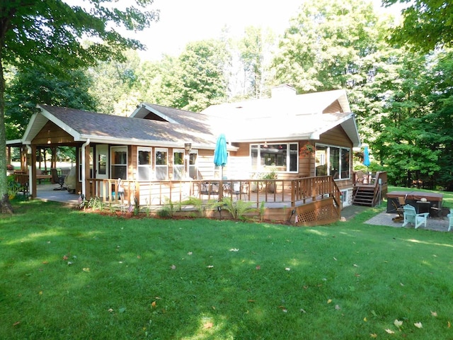 rear view of house featuring a deck, a patio, and a yard