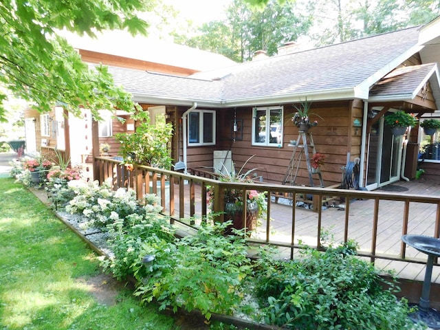 rear view of property featuring a deck