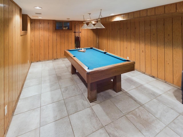 rec room with light tile patterned flooring, wooden walls, and billiards