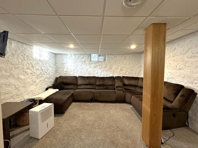 carpeted living room with a drop ceiling