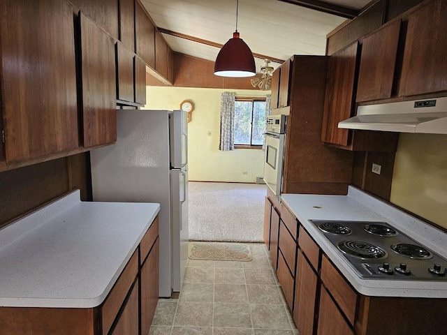 kitchen featuring lofted ceiling, decorative light fixtures, white appliances, and light tile patterned floors