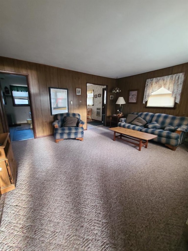 living room with carpet flooring and wood walls