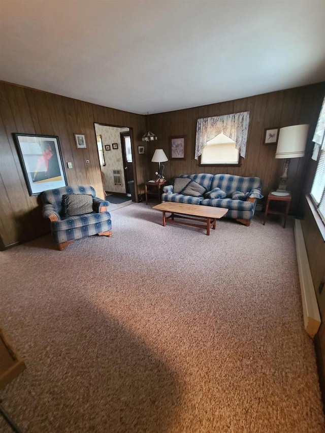 living room featuring carpet flooring and wood walls