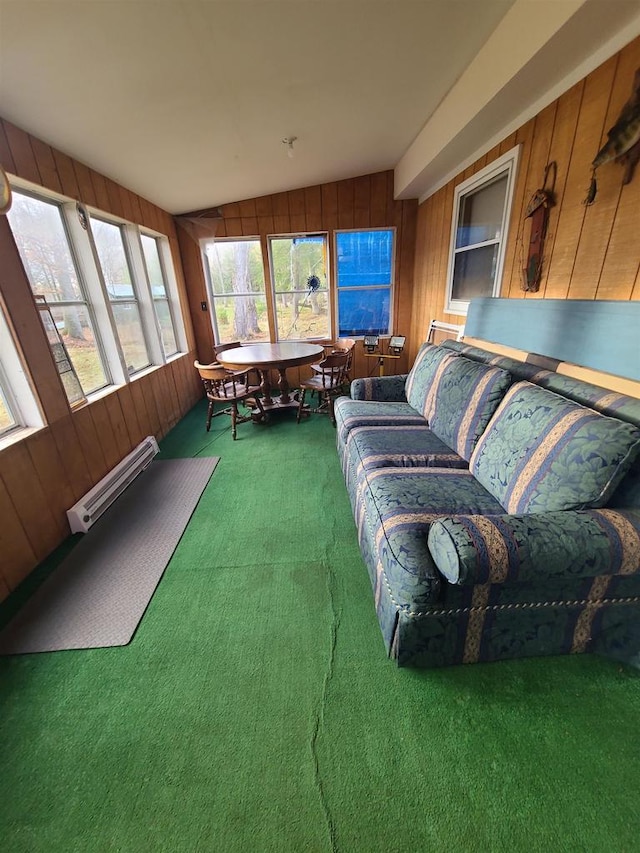 sunroom / solarium with lofted ceiling and a baseboard radiator