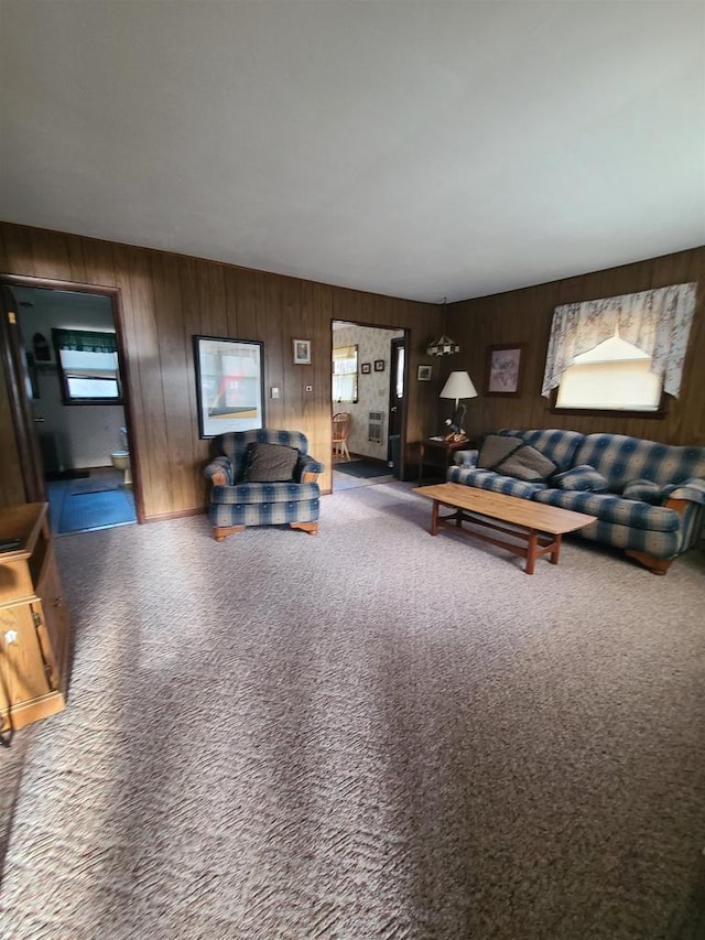 living room with wood walls and carpet