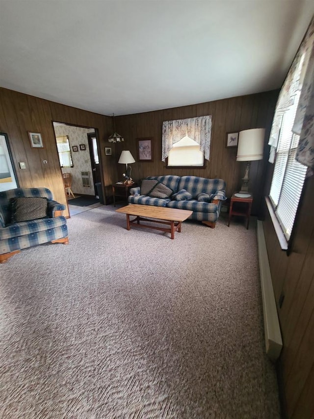 carpeted living room with wood walls