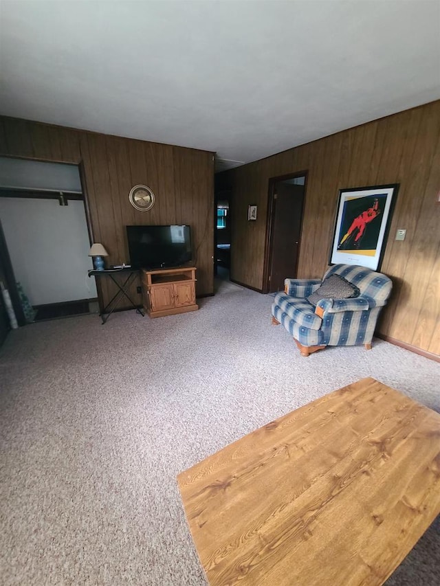 living room with wooden walls and carpet floors