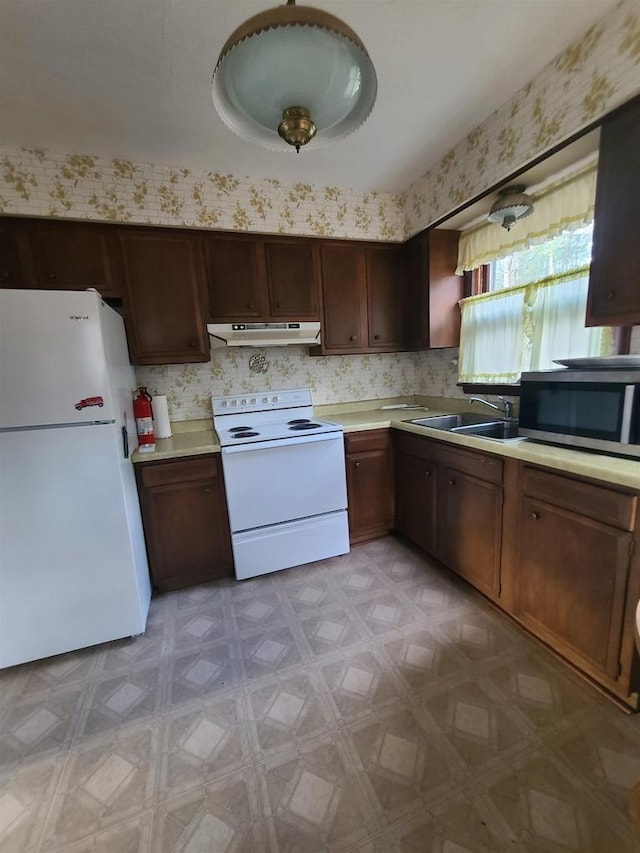 kitchen featuring white appliances and sink