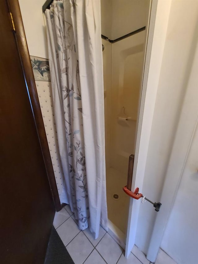 bathroom with tile patterned flooring and curtained shower