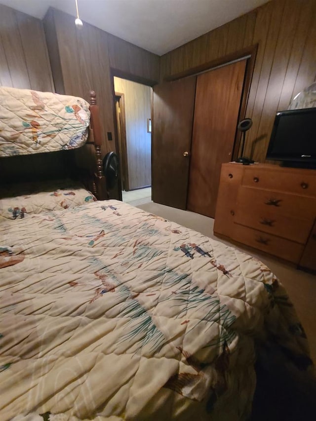 bedroom with wood walls and a closet