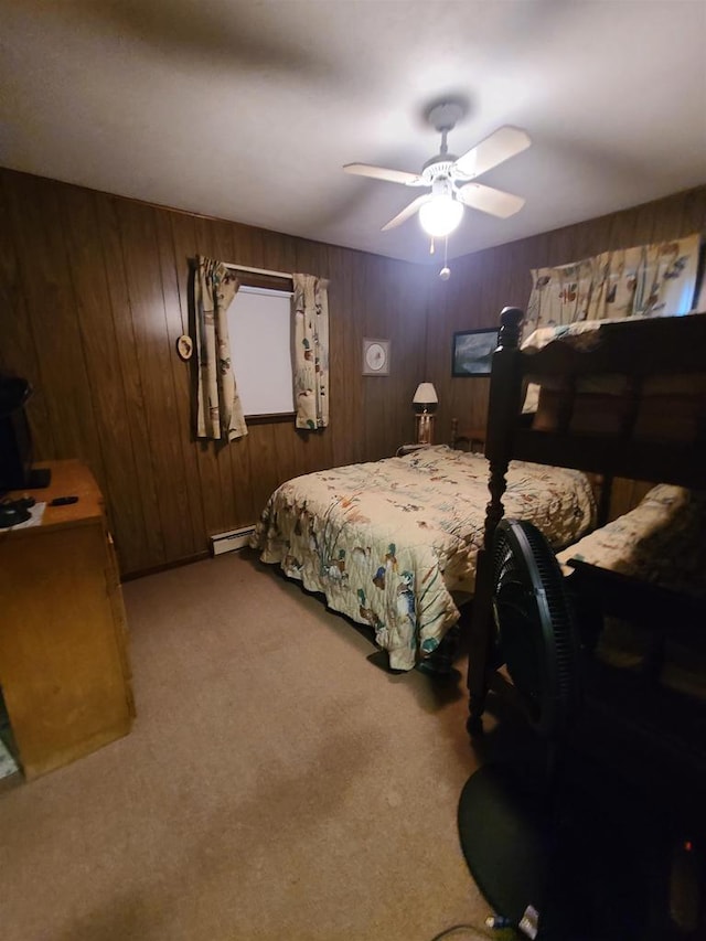 carpeted bedroom featuring wooden walls, ceiling fan, and a baseboard heating unit