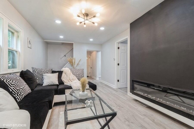 living room featuring light hardwood / wood-style flooring and a chandelier