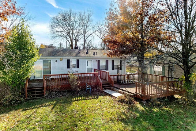 back of house featuring a lawn and a deck