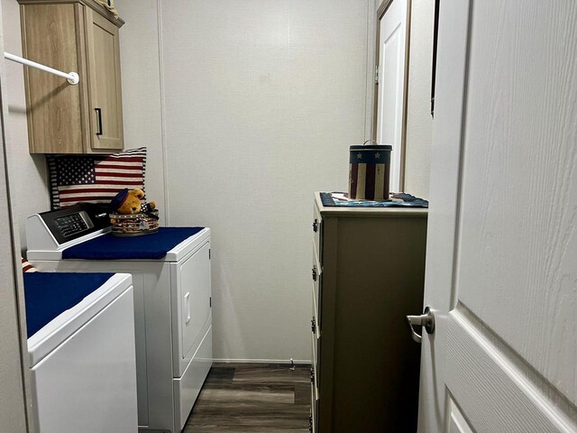 laundry room featuring separate washer and dryer, cabinets, and dark hardwood / wood-style floors