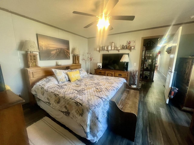 bedroom with ceiling fan, dark hardwood / wood-style floors, and ornamental molding