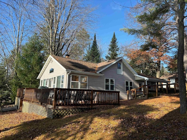 rear view of property featuring a deck