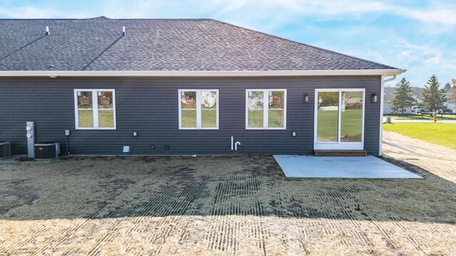 rear view of house featuring a patio and cooling unit