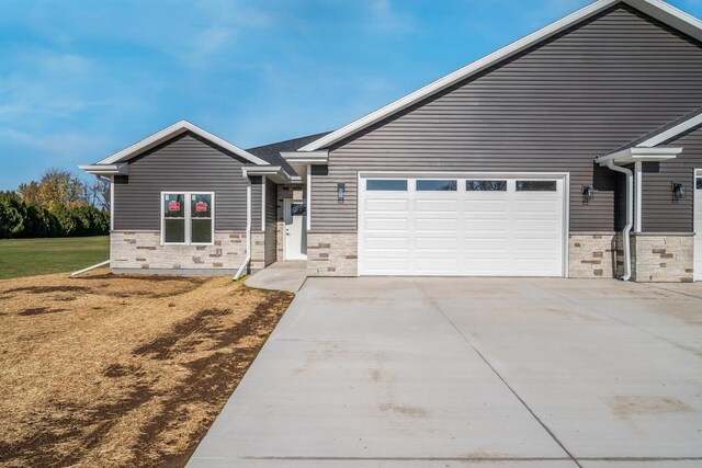 view of front of property with a front yard and a garage