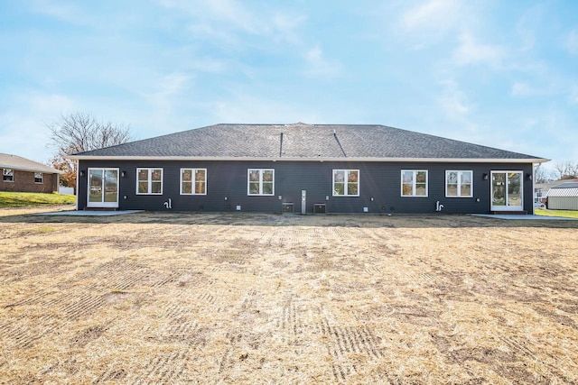 rear view of property with a patio and a lawn