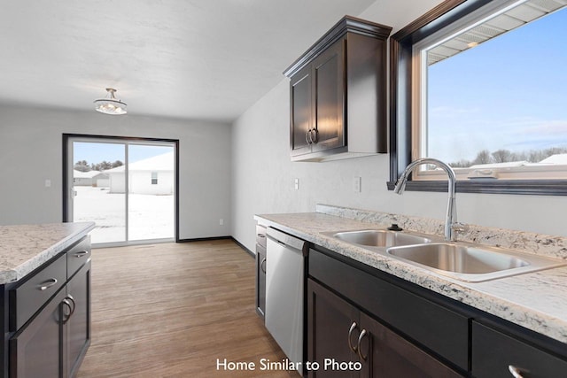 kitchen featuring dark brown cabinetry, light hardwood / wood-style floors, sink, and dishwasher