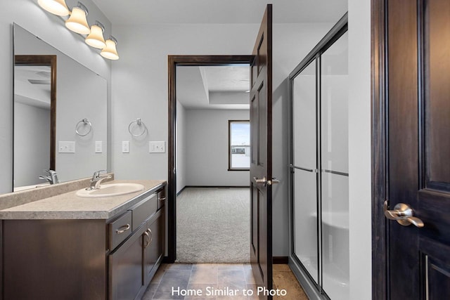 bathroom featuring vanity and an enclosed shower