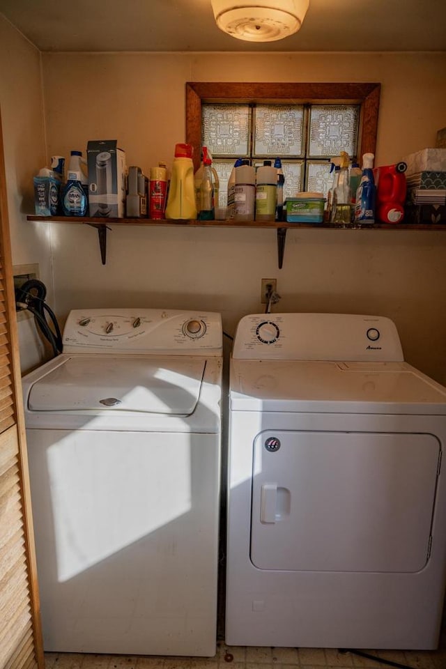 clothes washing area featuring separate washer and dryer