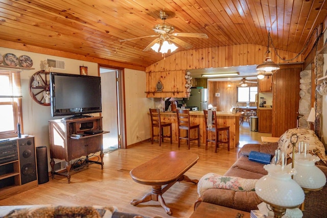 living room with light hardwood / wood-style flooring, vaulted ceiling, ceiling fan, and wooden ceiling