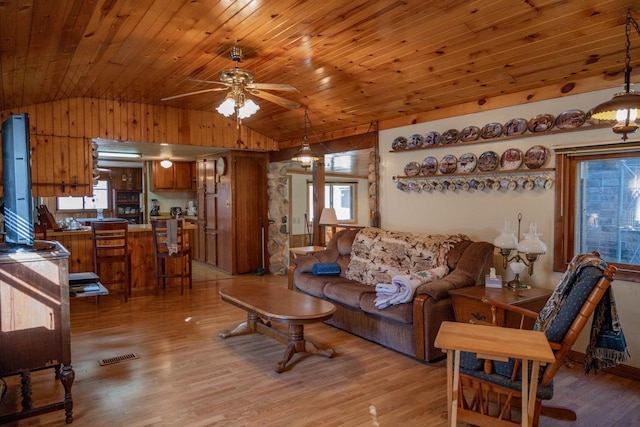 living room featuring light wood-type flooring, vaulted ceiling, and ceiling fan