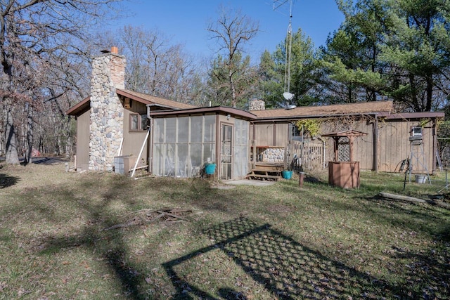 rear view of property featuring a yard