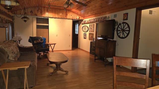 living room with light hardwood / wood-style floors, vaulted ceiling, ceiling fan, and wooden ceiling