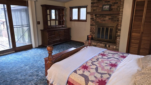 bedroom featuring access to exterior, carpet floors, a closet, and a fireplace