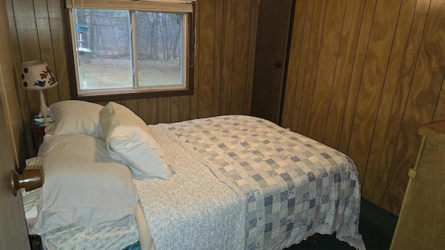 bedroom featuring wood walls