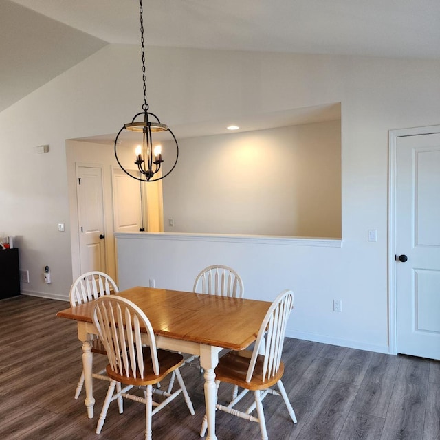 dining room with dark hardwood / wood-style flooring, vaulted ceiling, and a notable chandelier