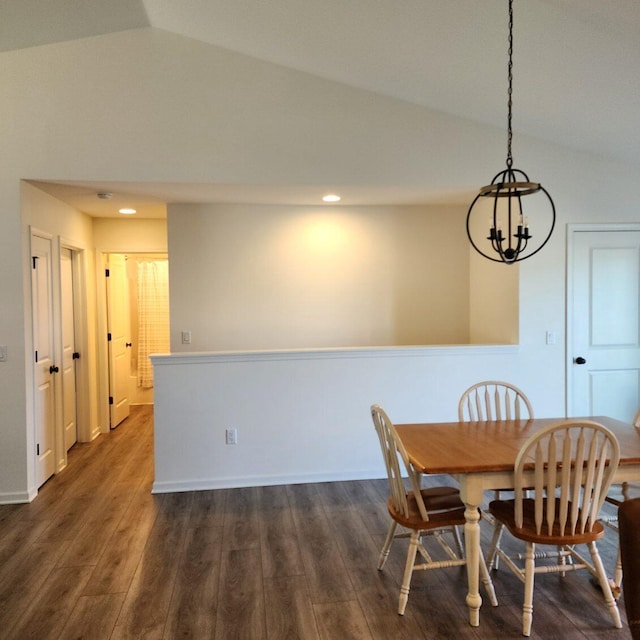 dining space featuring a chandelier, dark hardwood / wood-style floors, and lofted ceiling