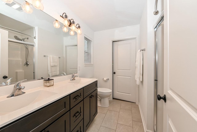 bathroom featuring toilet, a shower with door, vanity, and tile patterned flooring