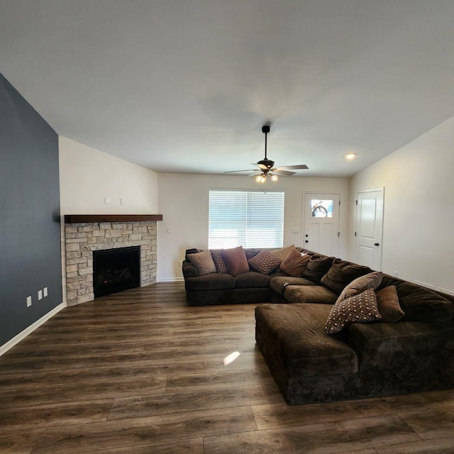 living room featuring a fireplace, ceiling fan, dark hardwood / wood-style flooring, and vaulted ceiling