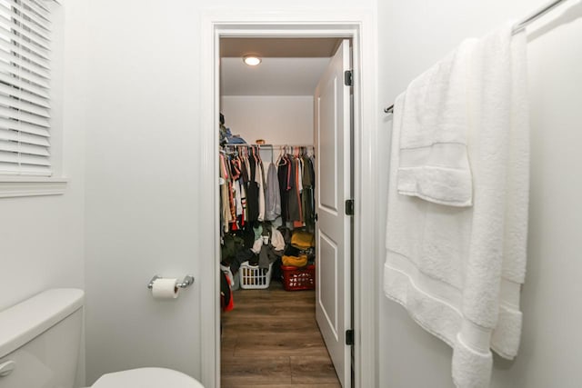 bathroom featuring hardwood / wood-style flooring and toilet