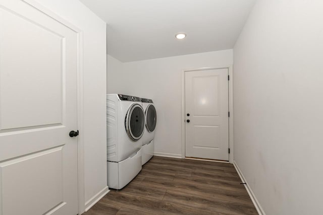 laundry area with washer and dryer and dark hardwood / wood-style floors