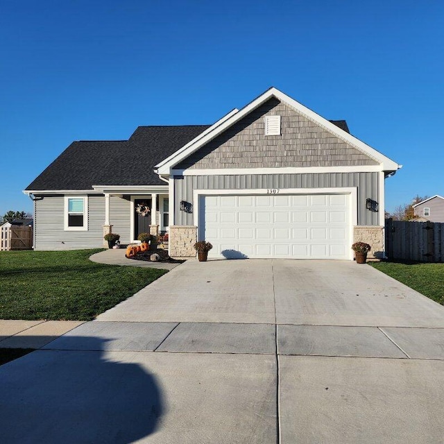 ranch-style home featuring a front yard and a garage