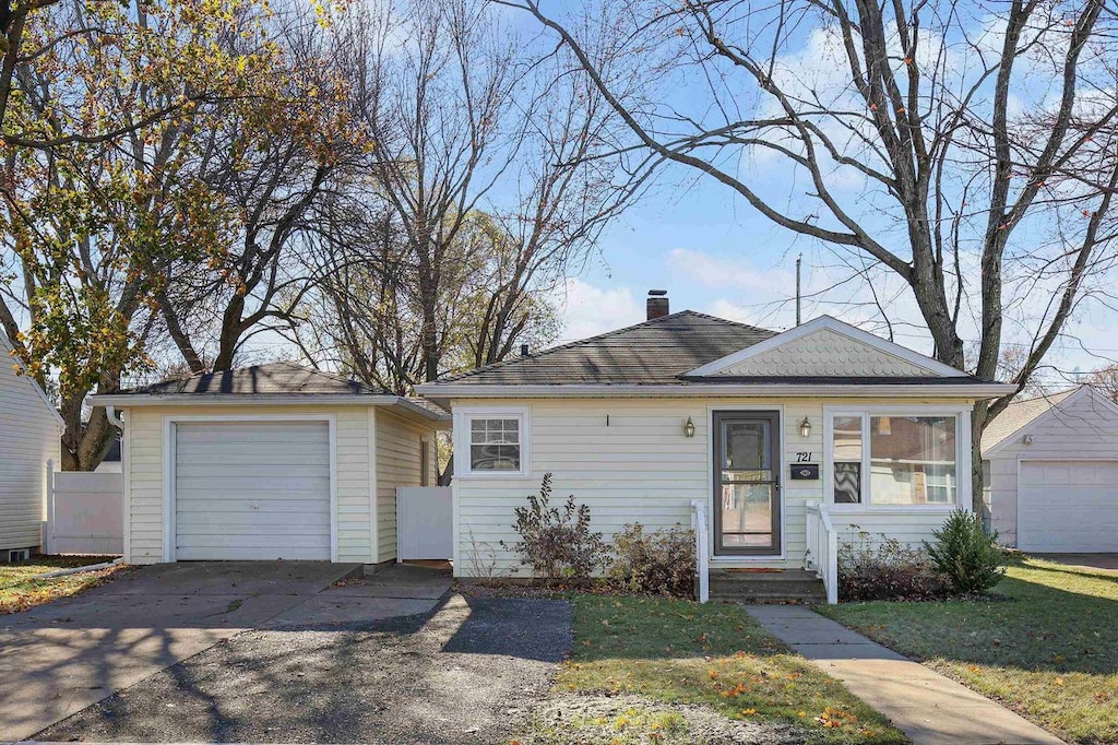 view of front of home with a garage and an outdoor structure