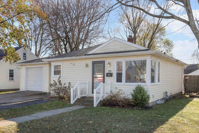 bungalow-style house featuring a front yard and a garage