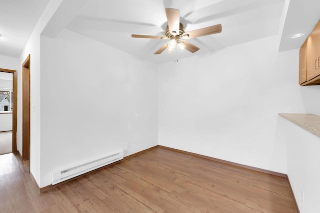 empty room with a baseboard radiator, light hardwood / wood-style floors, and ceiling fan