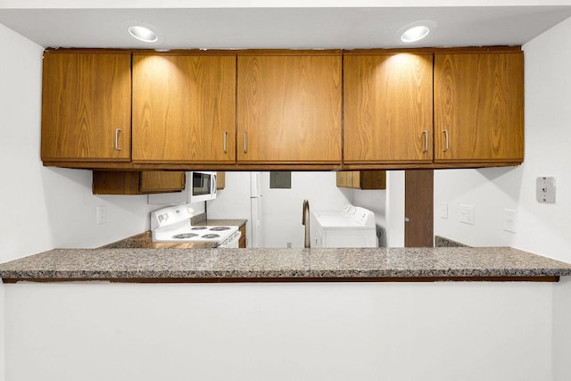 kitchen with white appliances and stone countertops