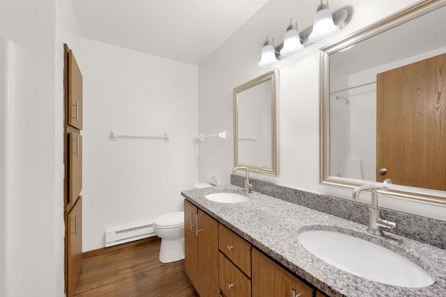 bathroom with a baseboard radiator, vanity, hardwood / wood-style flooring, and toilet