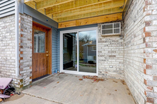 view of exterior entry featuring a wall mounted AC