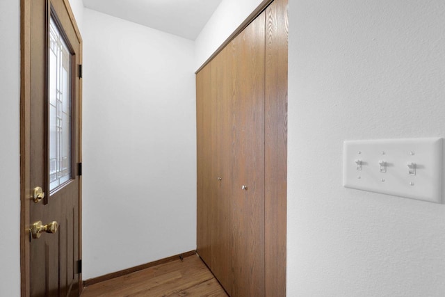 corridor with light wood-type flooring