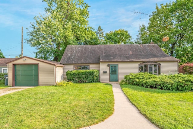 view of front of home featuring a garage, an outdoor structure, and a front lawn