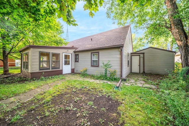 rear view of property with a sunroom