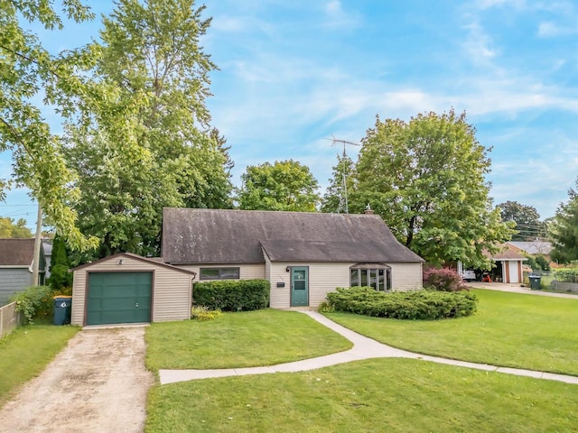 view of front facade with an outbuilding, a front yard, and a garage